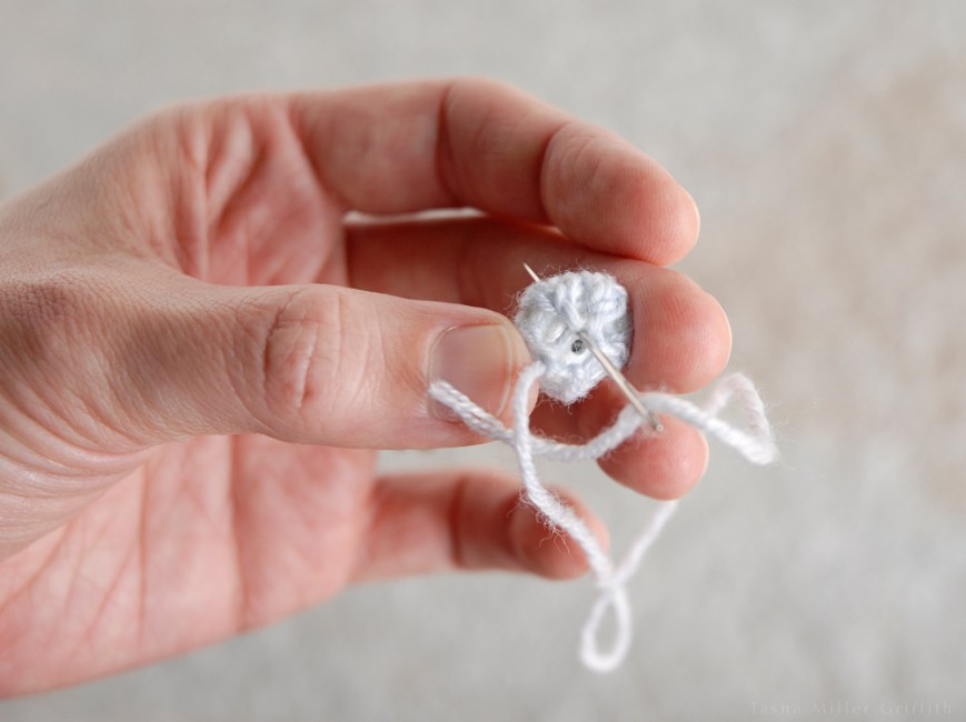 tiny knit covered buttons stitching through button