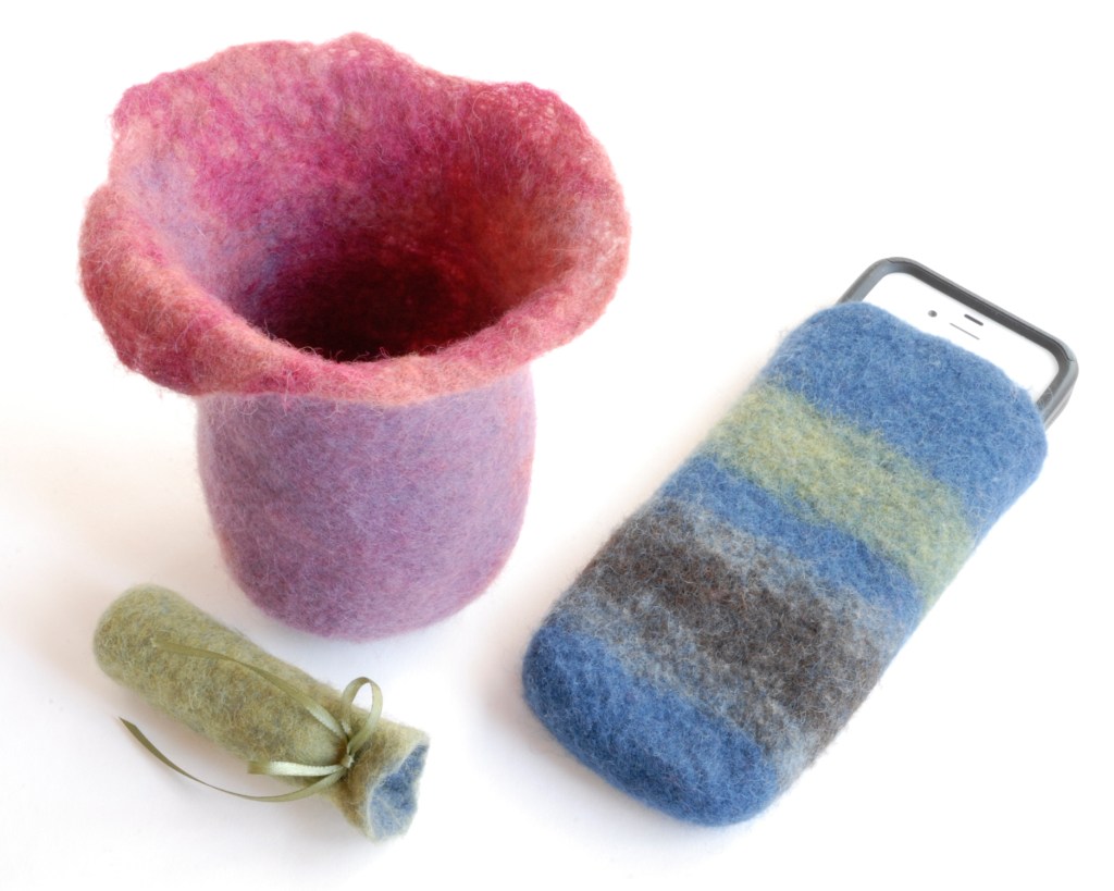 Small 3D felted objects; a phone case, a vessel with an open top, and a tiny tube